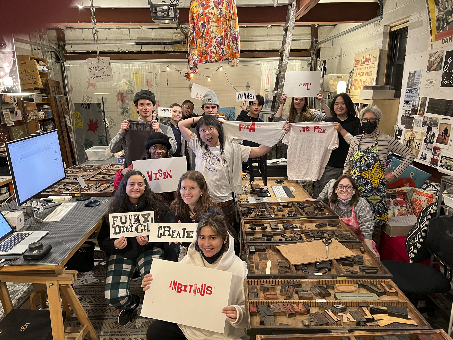 Tisch students holding prints made with hand-set type